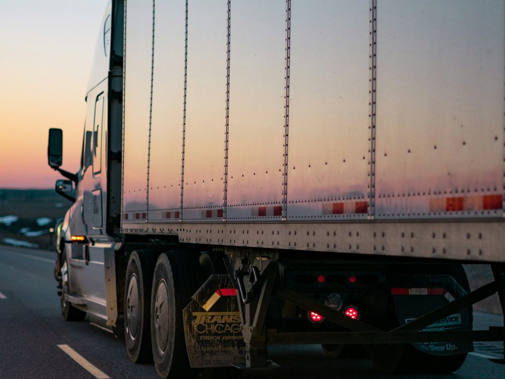 Lastbil med trailer på väg i kvällsljus